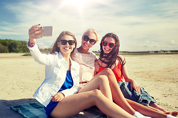 Image showing group of smiling women taking selfie on beach