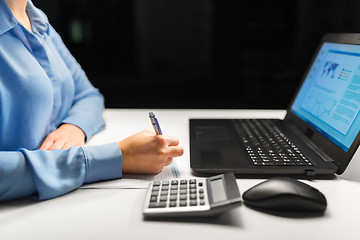 Image showing businesswoman with papers working at night office