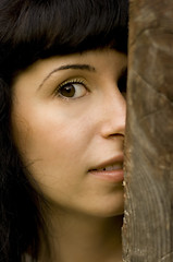 Image showing girl hiding behind a tree