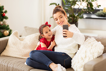 Image showing family taking selfie by smartphone at home