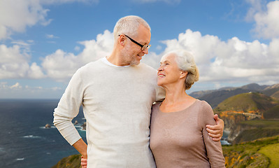 Image showing happy senior couple hugging over big sur coast