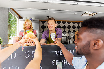 Image showing happy customers buying burger at food truck