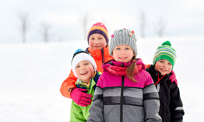 Image showing happy little kids in winter clothes outdoors