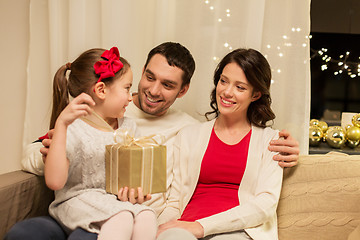 Image showing happy family with christmas present at home