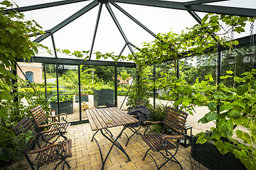 Image showing Terrace in a glass house with wooden garden furniture