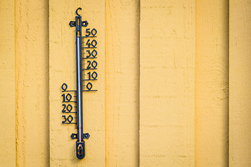 Image showing Weather thermometer hanging on a yellow wall