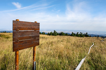 Image showing Wooden multi sign on the top of a hill