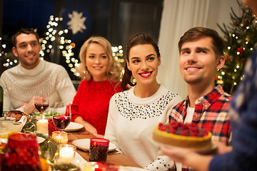 Image showing happy friends having christmas dinner at home