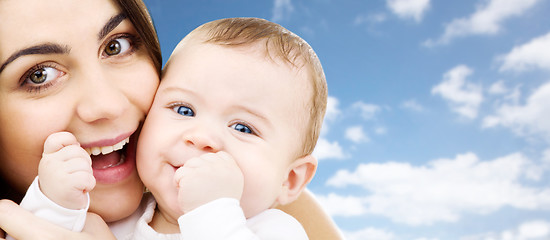 Image showing mother with baby over sky background