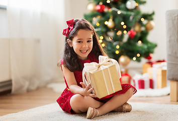 Image showing happy girl with christmas gift at home