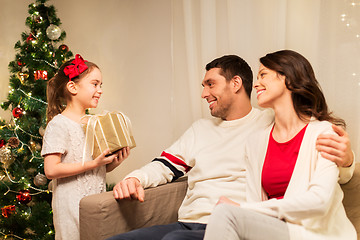 Image showing happy family with christmas present at home