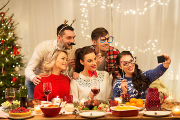 Image showing friends taking selfie at christmas dinner