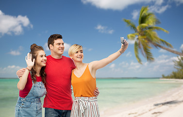 Image showing friends taking selfie by smartphone and hugging