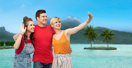 Image showing friends taking selfie by smartphone over bora bora