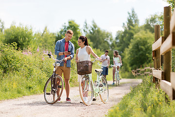 Image showing couple with bicycles and smartphone in summer