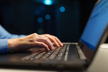 Image showing close up of female hands with laptop typing