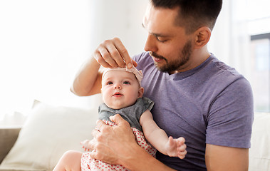 Image showing close up of father with little baby girl at home