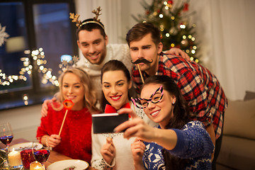 Image showing friends taking selfie at christmas dinner