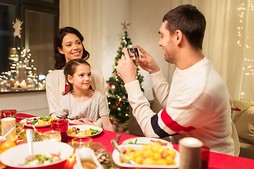 Image showing happy family taking picture at christmas dinner