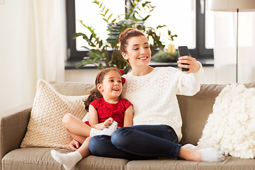 Image showing family taking selfie by smartphone at home