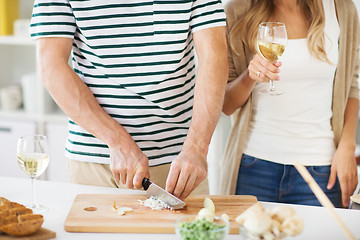 Image showing couple cooking food and drinking wine at home