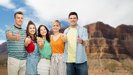 Image showing friends showing thumbs up over grand canyon