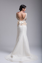 Image showing Rear view of a beautiful young woman in a wedding dress