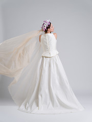 Image showing Rear view of a beautiful young woman in a wedding dress