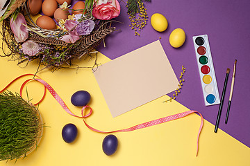 Image showing Easter card. Painted Easter eggs in nest on yellow background