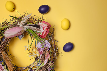 Image showing Easter card. Painted Easter eggs in nest on yellow background