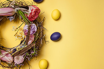 Image showing Easter card. Painted Easter eggs in nest on yellow background