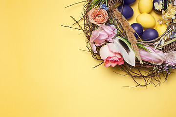 Image showing Easter card. Painted Easter eggs in nest on yellow background