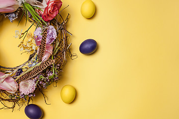 Image showing Easter card. Painted Easter eggs in nest on yellow background