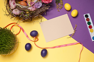 Image showing Easter card. Painted Easter eggs in nest on yellow background