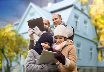 Image showing family with tablet pc over living house in autumn