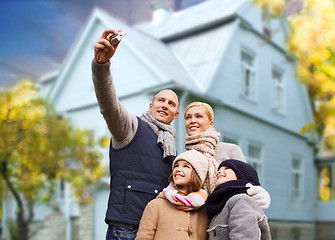 Image showing family takes autumn selfie by camera over house