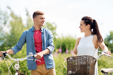 Image showing happy couple with fixed gear bicycles in summer