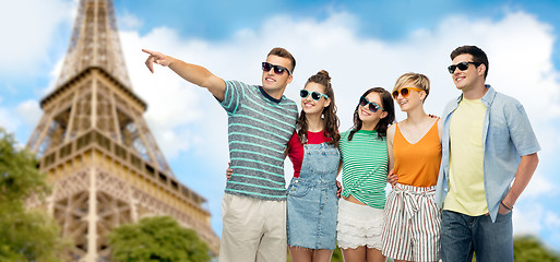 Image showing friends in sunglasses over eiffel tower background