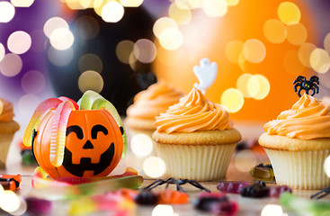 Image showing halloween party decorated cupcakes on wooden table