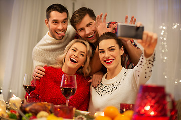 Image showing friends taking selfie at christmas dinner