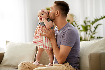 Image showing father kissing little baby daughter