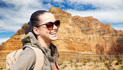 Image showing smiling woman with backpack over grand canyon