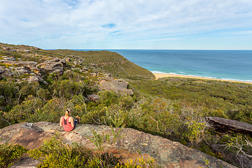 Image showing Weekend time, relaxing on a rocky ledge near the ocean