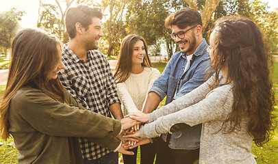 Image showing Happy Friends joining hands\r