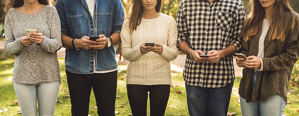 Image showing Friends distracted with social networks