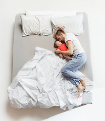 Image showing Top view of happy family with one newborn child in bedroom.