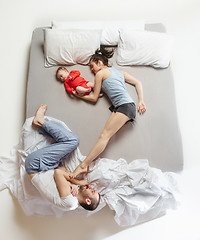 Image showing Top view of happy family with one newborn child in bedroom.