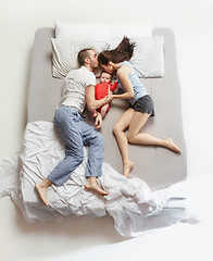 Image showing Top view of happy family with one newborn child in bedroom.