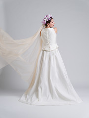 Image showing Rear view of a beautiful young woman in a wedding dress