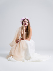 Image showing young bride sitting in a wedding dress